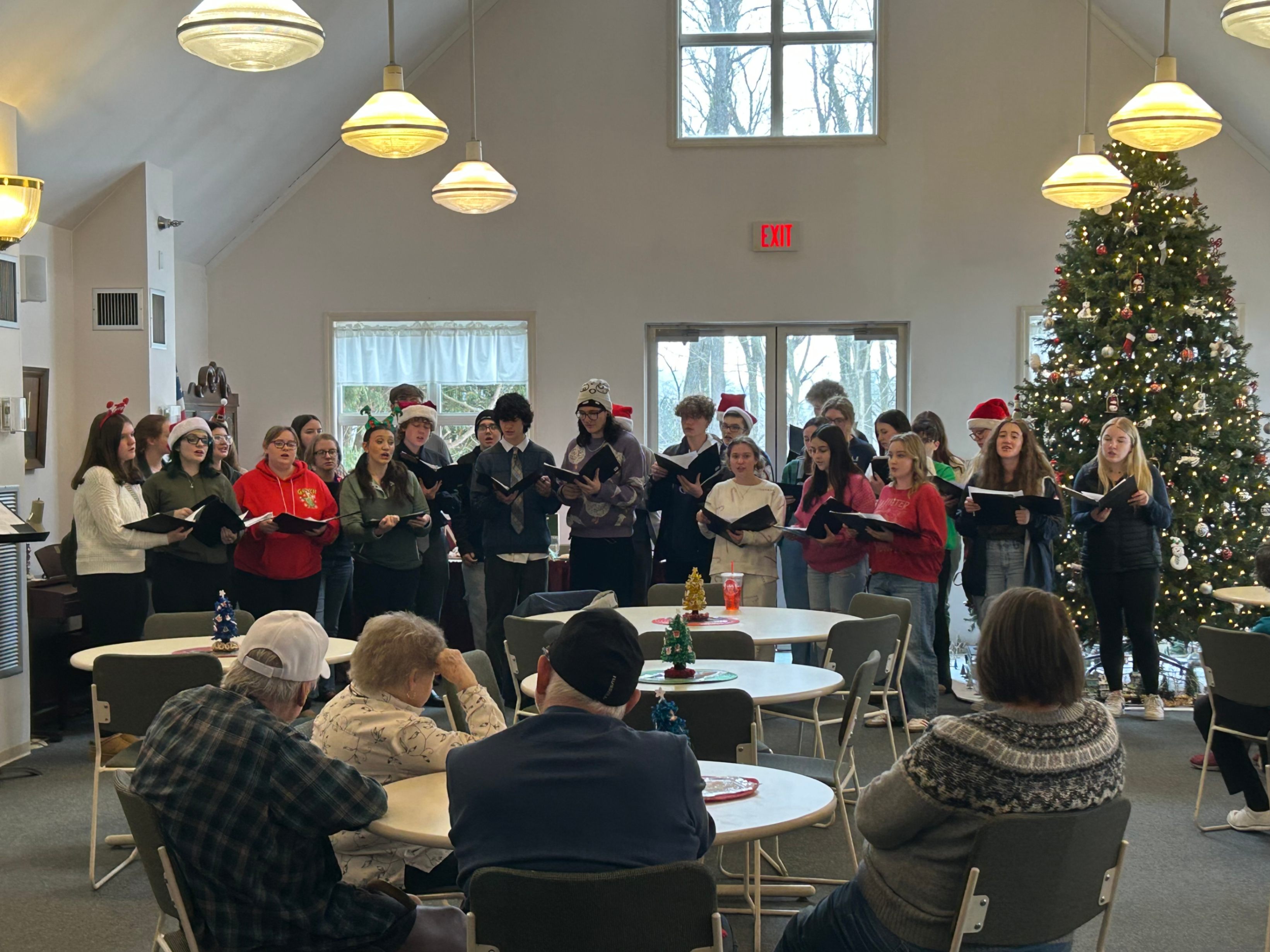 Students sing for area nursing home residents.